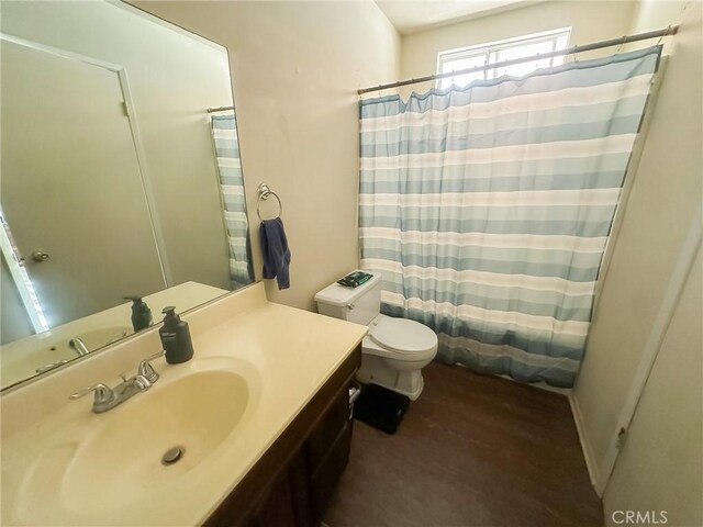 5374 Morongo Rd Unit 29, Palms, CA 92277 - full bath featuring toilet, vanity, a shower with shower curtain, and wood finished floors