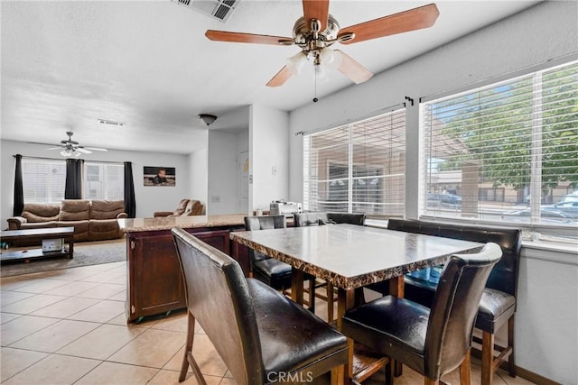 2017 Harvard Dr, Barstow, CA 92311 - dining space with ceiling fan, healthy amount of natural light, and light tile patterned flooring