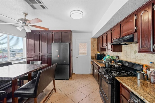 2017 Harvard Dr, Barstow, CA 92311 - kitchen with black appliances, under cabinet range hood, tasteful backsplash, a ceiling fan, and light tile patterned flooring