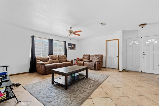 2017 Harvard Dr, Barstow, CA 92311 - living area featuring light tile patterned flooring, a ceiling fan, and baseboards