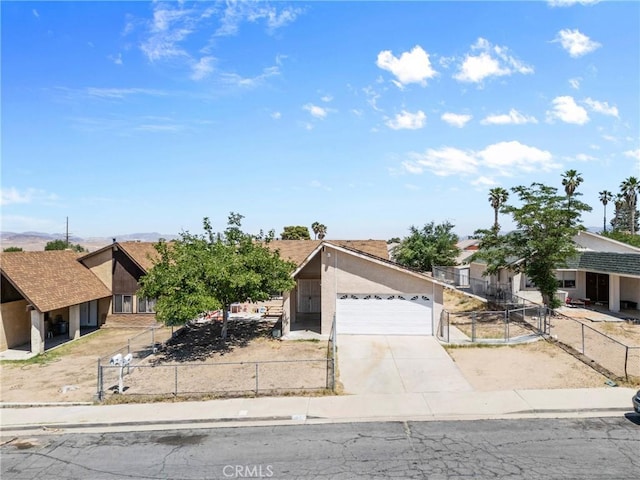 2017 Harvard Dr, Barstow, CA 92311 - view of front of home featuring an attached garage, concrete driveway, stucco siding, and a fenced front yard
