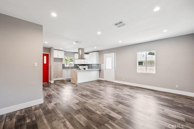 7719 Nestle Ave, Reseda, CA 91335 - unfurnished living room featuring dark wood-style flooring, baseboards, recessed lighting, and a sink