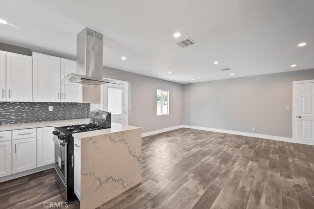 7719 Nestle Ave, Reseda, CA 91335 - kitchen featuring gas range oven, island range hood, backsplash, recessed lighting, and white cabinetry