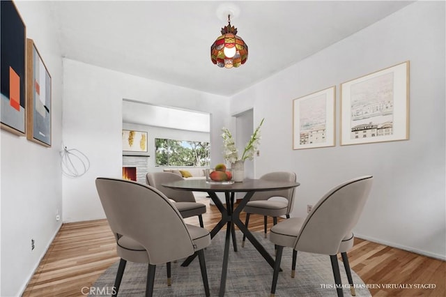 305 Raymondale Dr Unit L, South Pasadena, CA 91030 - dining space featuring wood finished floors and a warm lit fireplace