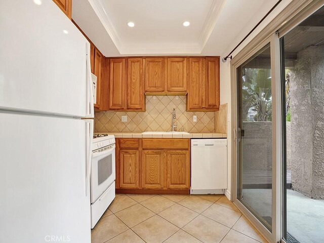 16879 Bluewater Ln Unit 25, Huntington Beach, CA 92649 - kitchen featuring white appliances, a sink, decorative backsplash, light tile patterned floors, and a raised ceiling