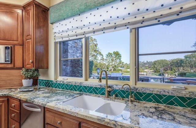 4843 La Jacaranda, Rancho Santa Fe, CA 92067 - kitchen with a sink, light stone counters, and brown cabinets