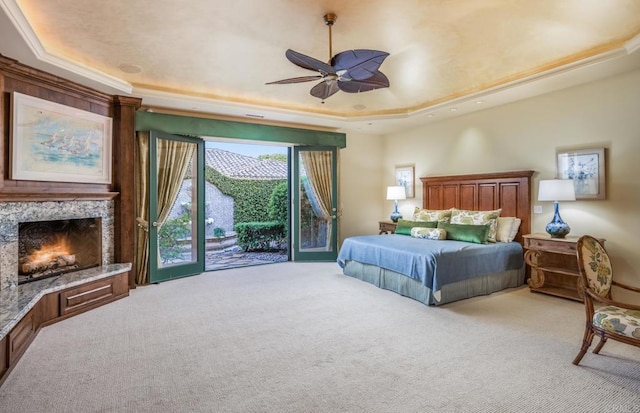 4843 La Jacaranda, Rancho Santa Fe, CA 92067 - bedroom with a tray ceiling, access to outside, light carpet, a fireplace, and a ceiling fan