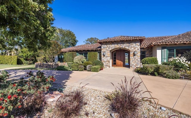 4843 La Jacaranda, Rancho Santa Fe, CA 92067 - mediterranean / spanish-style home featuring stone siding, a tiled roof, and stucco siding