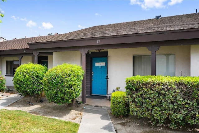 2011 W Katella Ave Unit 17, Anaheim, CA 92804 - view of exterior entry featuring stucco siding and a shingled roof
