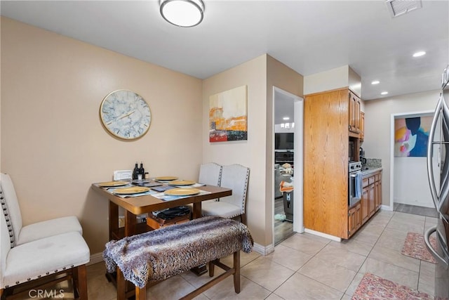 2011 W Katella Ave Unit 17, Anaheim, CA 92804 - dining space with baseboards, recessed lighting, and light tile patterned floors