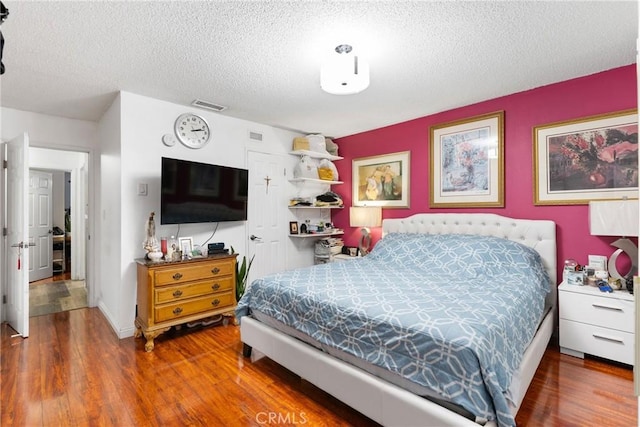 2011 W Katella Ave Unit 17, Anaheim, CA 92804 - bedroom with wood finished floors and a textured ceiling