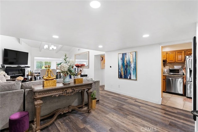 2011 W Katella Ave Unit 17, Anaheim, CA 92804 - living area with a chandelier, vaulted ceiling, recessed lighting, light wood-style flooring, and baseboards