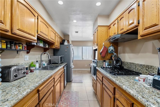 2011 W Katella Ave Unit 17, Anaheim, CA 92804 - kitchen featuring appliances with stainless steel finishes, under cabinet range hood, open shelves, light stone counters, and light tile patterned floors