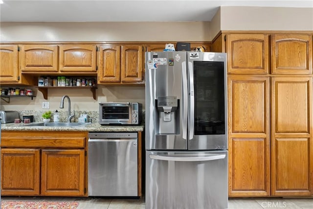 2011 W Katella Ave Unit 17, Anaheim, CA 92804 - kitchen featuring stainless steel appliances, brown cabinets, light countertops, and open shelves