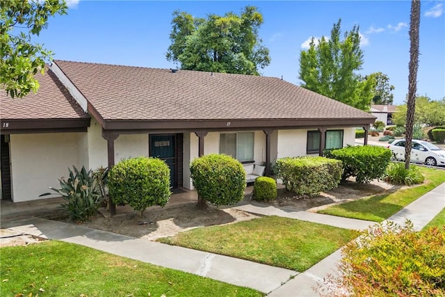 2011 W Katella Ave Unit 17, Anaheim, CA 92804 - view of front of property with stucco siding, a front lawn, and roof with shingles