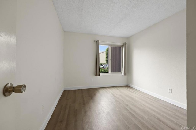 5938 Rancho Mission Rd Unit 133, San Diego, CA 92108 - spare room with wood finished floors, a textured ceiling, and baseboards