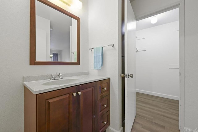 5938 Rancho Mission Rd Unit 133, San Diego, CA 92108 - bathroom with vanity, wood finished floors, and baseboards