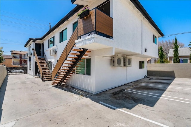 4071 Melrose Ave Unit 1, Los Angeles, CA 90029 - view of side of home with stairs, a cooling unit, and uncovered parking