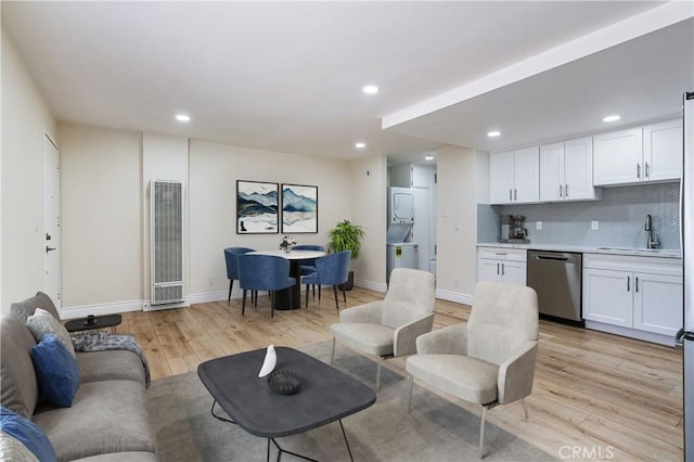 4071 Melrose Ave Unit 1, Los Angeles, CA 90029 - living room featuring stacked washer / dryer, a heating unit, light wood-type flooring, and recessed lighting