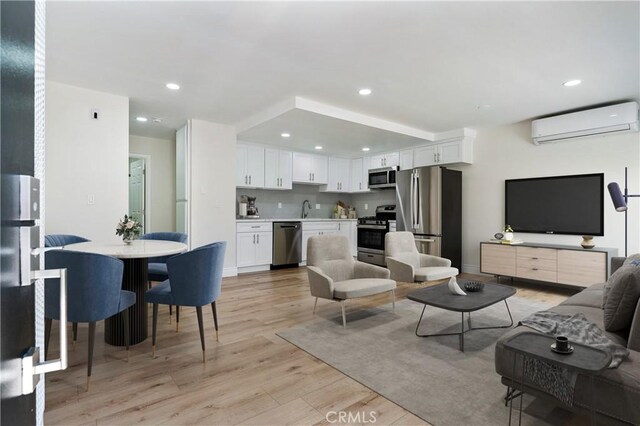 4071 Melrose Ave Unit 1, Los Angeles, CA 90029 - living room featuring a wall mounted air conditioner, light wood-type flooring, and recessed lighting