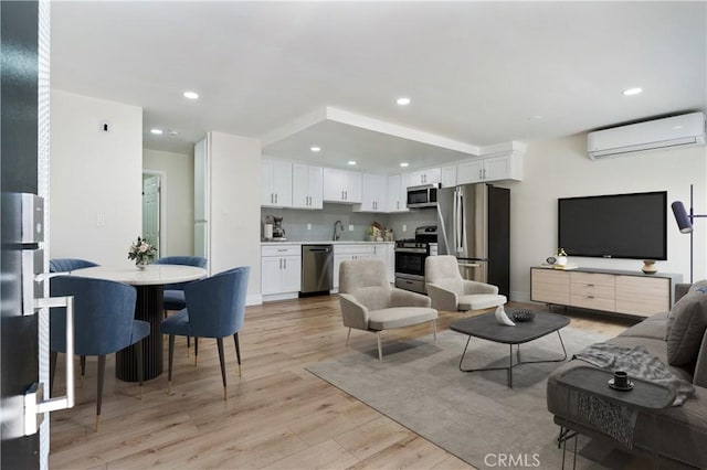 4071 Melrose Ave Unit 1, Los Angeles, CA 90029 - living area featuring a wall mounted air conditioner, light wood-style floors, and recessed lighting