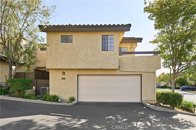 1202 Monte Sereno Dr, Thousand Oaks, CA 91360 - view of front facade with asphalt driveway, a garage, central AC unit, and stucco siding