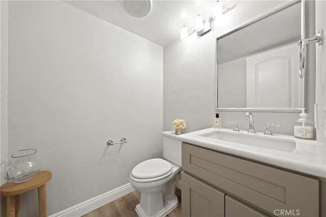 1202 Monte Sereno Dr, Thousand Oaks, CA 91360 - half bathroom featuring wood finished floors, toilet, vanity, and baseboards