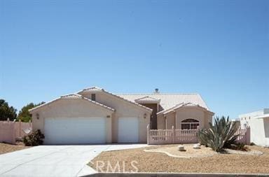 26538 Mainsail Ln, Helendale, CA 92342 - ranch-style house with a garage, driveway, and stucco siding