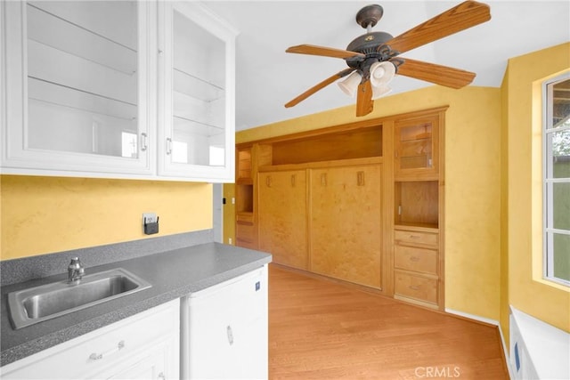12071 Reva Dr, Garden Grove, CA 92840 - kitchen featuring a sink, light wood finished floors, white cabinets, and a ceiling fan