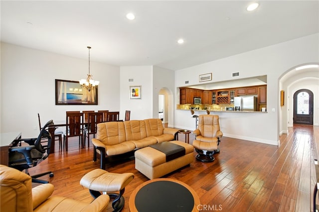 1835 S Barrington Ave Unit Ph2, Los Angeles, CA 90025 - living room with arched walkways, a chandelier, recessed lighting, wood finished floors, and baseboards