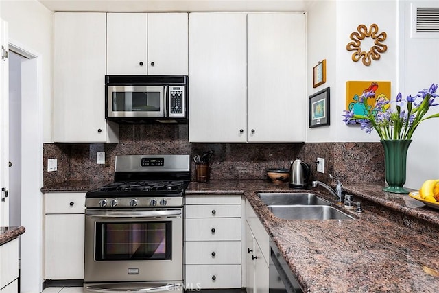 1045 S Orange Grove Blvd Unit 4, Pasadena, CA 91105 - kitchen featuring appliances with stainless steel finishes, a sink, white cabinetry, decorative backsplash, and dark stone countertops