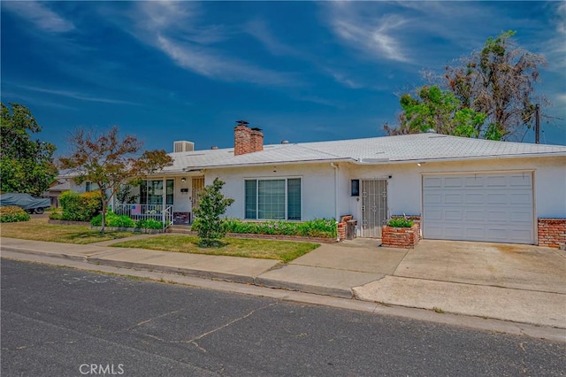 1640 Shirley St, Merced, CA 95341 - ranch-style home featuring concrete driveway, a garage, a chimney, and stucco siding