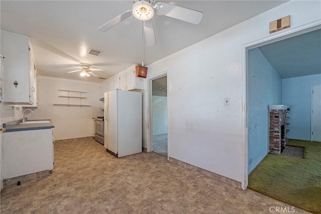 1640 Shirley St, Merced, CA 95341 - kitchen with freestanding refrigerator, a ceiling fan, gas stove, white cabinetry, and a sink