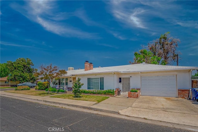 1640 Shirley St, Merced, CA 95341 - single story home with a garage, stucco siding, a chimney, and concrete driveway