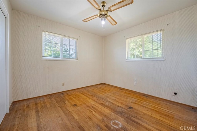 1640 Shirley St, Merced, CA 95341 - empty room with light wood finished floors, healthy amount of natural light, and a ceiling fan