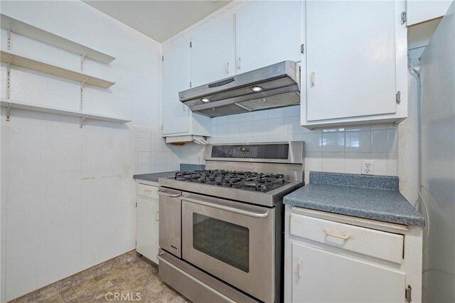 1640 Shirley St, Merced, CA 95341 - kitchen featuring double oven range, under cabinet range hood, tasteful backsplash, and white cabinetry