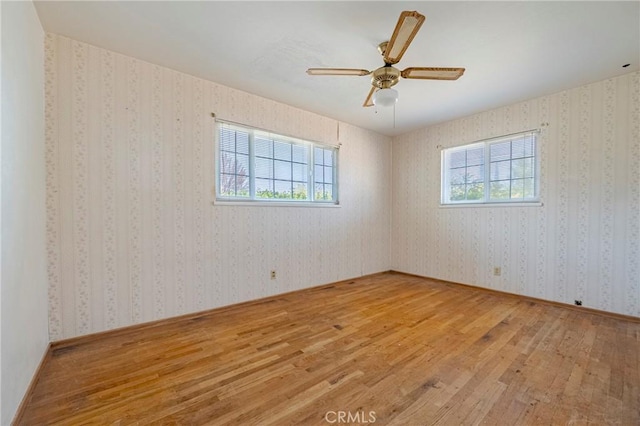 1640 Shirley St, Merced, CA 95341 - spare room with wood-type flooring, plenty of natural light, and wallpapered walls