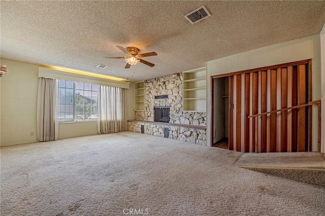 1640 Shirley St, Merced, CA 95341 - unfurnished living room featuring a ceiling fan, carpet floors, a textured ceiling, a fireplace, and built in features
