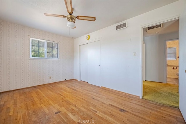 1640 Shirley St, Merced, CA 95341 - unfurnished bedroom with hardwood / wood-style flooring, wallpapered walls, a closet, and a ceiling fan