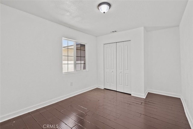 18531 E Palmdale Blvd, Palmdale, CA 93591 - unfurnished bedroom featuring baseboards, dark wood finished floors, and a closet