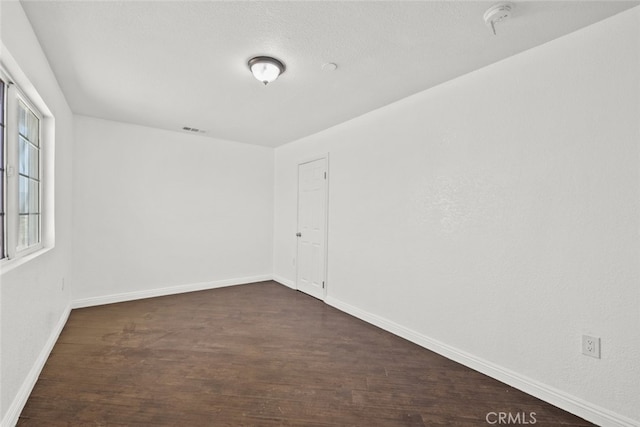 18531 E Palmdale Blvd, Palmdale, CA 93591 - empty room featuring dark wood-style flooring, baseboards, and a smoke detector