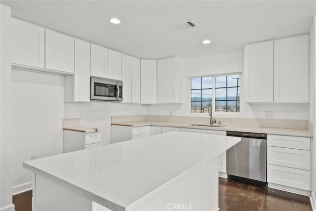 18531 E Palmdale Blvd, Palmdale, CA 93591 - kitchen with appliances with stainless steel finishes, a sink, dark wood-style flooring, recessed lighting, and white cabinets