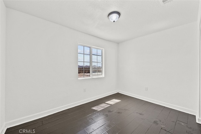 18531 E Palmdale Blvd, Palmdale, CA 93591 - spare room with dark wood-type flooring, baseboards, and a textured ceiling
