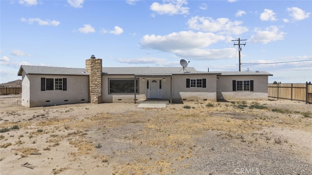18531 E Palmdale Blvd, Palmdale, CA 93591 - rear view of property with stucco siding and a chimney