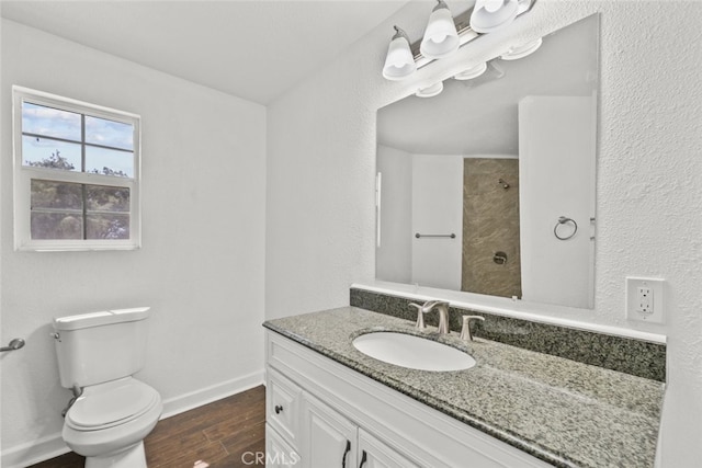 18531 E Palmdale Blvd, Palmdale, CA 93591 - bathroom featuring toilet, wood finished floors, vanity, baseboards, and a shower