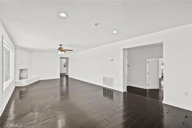 18531 E Palmdale Blvd, Palmdale, CA 93591 - unfurnished living room with ceiling fan, a stone fireplace, a textured ceiling, wood finished floors, and recessed lighting