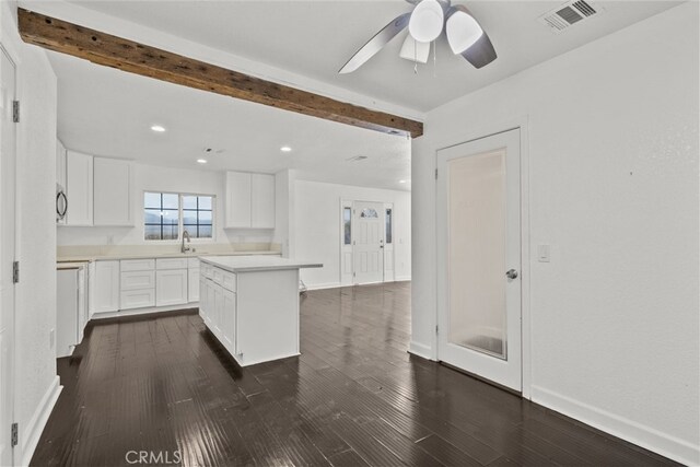 18531 E Palmdale Blvd, Palmdale, CA 93591 - kitchen featuring ceiling fan, dark wood-style flooring, white cabinets, light countertops, and beamed ceiling