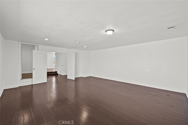 18531 E Palmdale Blvd, Palmdale, CA 93591 - unfurnished room featuring dark wood-style floors, recessed lighting, a textured ceiling, and baseboards
