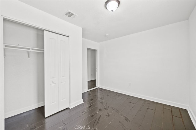 18531 E Palmdale Blvd, Palmdale, CA 93591 - unfurnished bedroom featuring a closet, baseboards, and dark wood-style floors