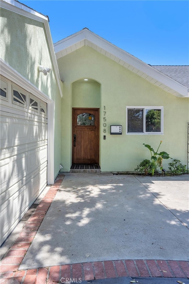 17508 Strathern St, Northridge, CA 91325 - doorway to property featuring stucco siding and a garage